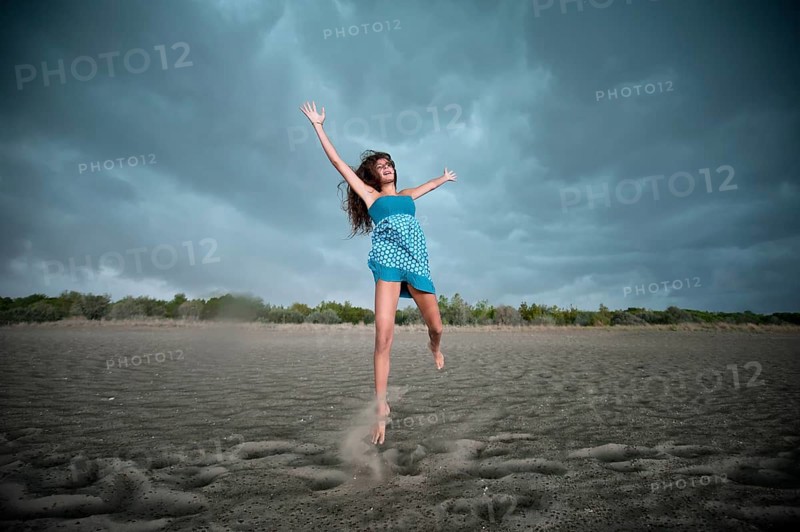 Girl jumping on a beach