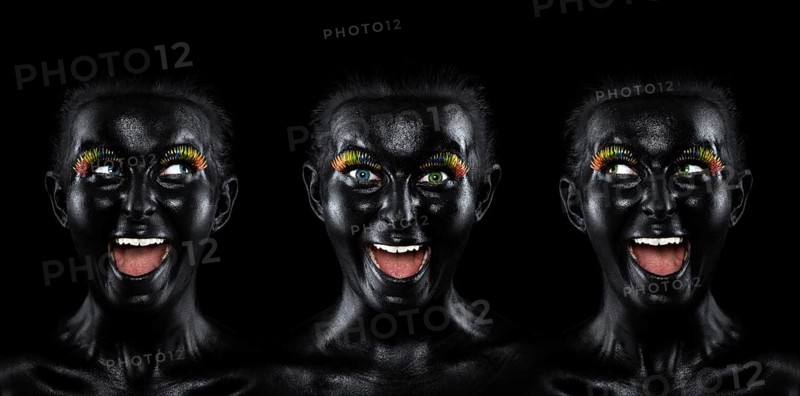 Triple faces of a laughing young woman painted with black facepaint
