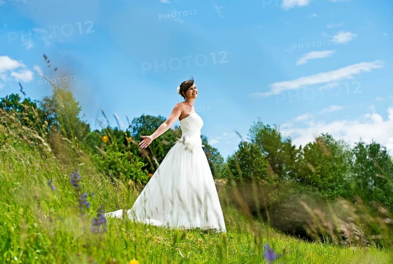 Bride standing on a meadow in Tyrol