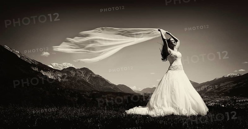 Bride holding a flowing scarf in the Tyrolean Alps