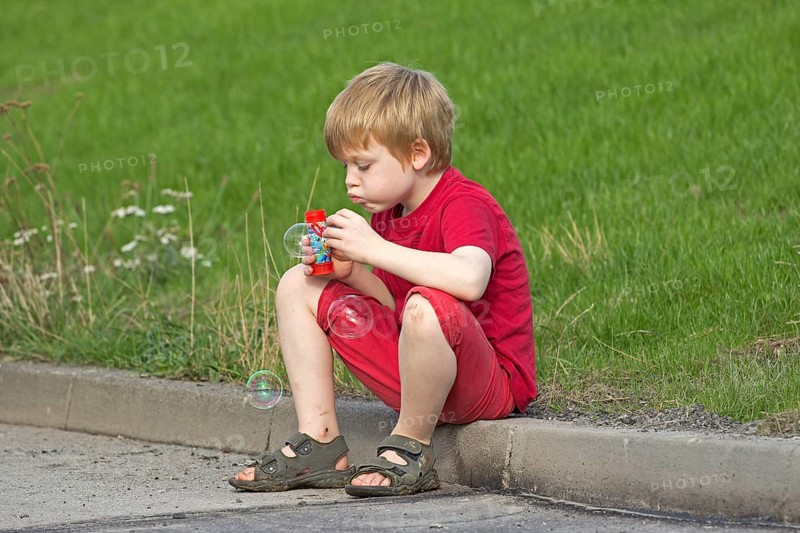 Young boy blowing bubbles