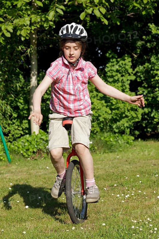 Girl riding a unicycle