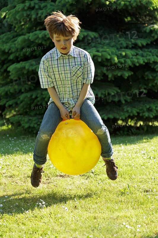 Boy jumping with a hop ball