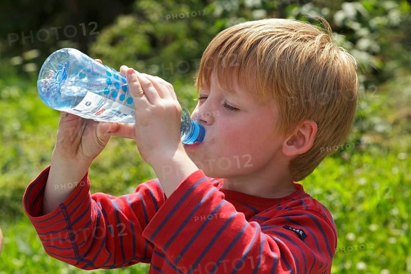 Young boy drinking water