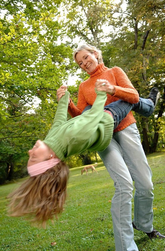 Mother and daughter run around in the park