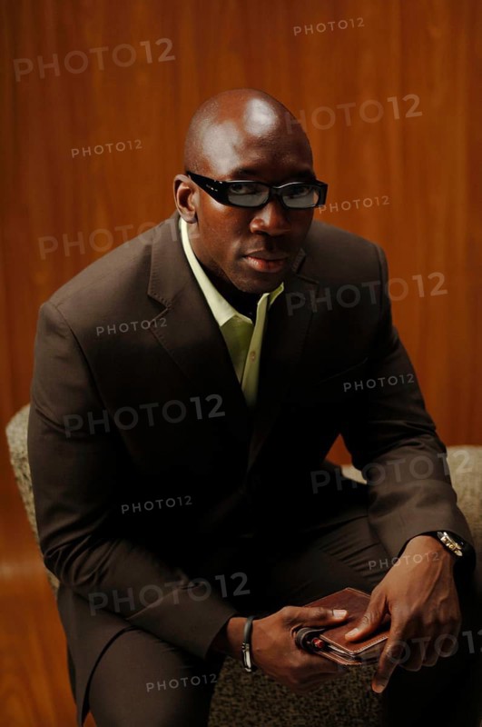 Bald man in a suit with glasses