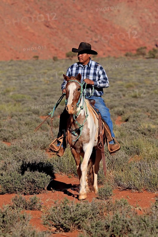 Navajo cowboy riding on a Mustang