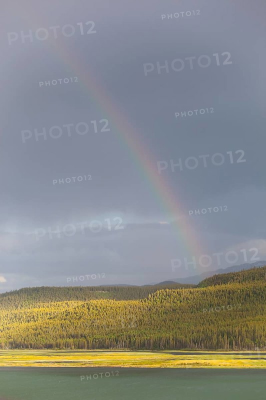 Heavy clouds and rainbow over Marsh Lake