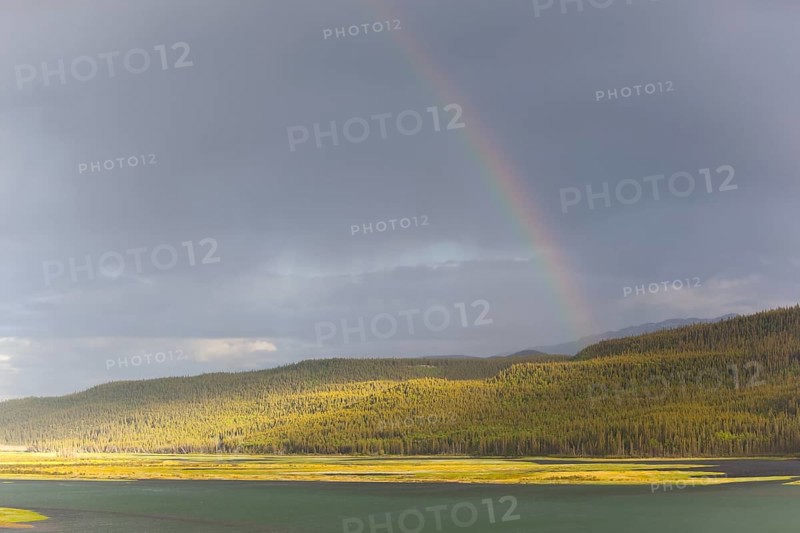 Heavy clouds and rainbow over Marsh Lake