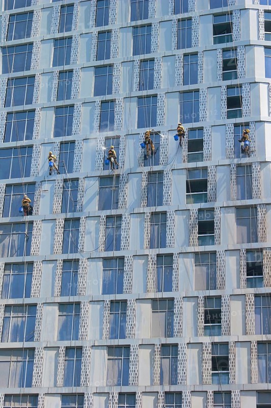 Window cleaners working on the facade of a skyscraper