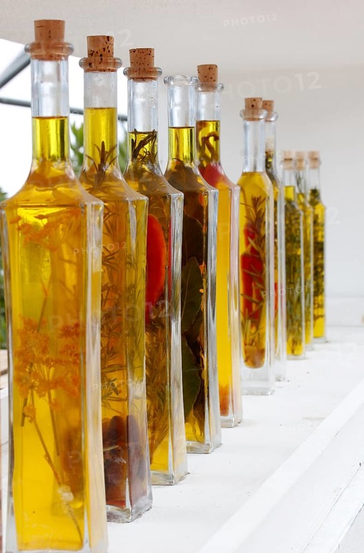 Bottles with olive oil and herbs