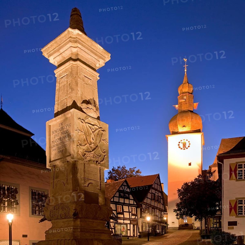 Maximilian Fountain in Alter Markt square with the old town hall and the bell tower at dusk