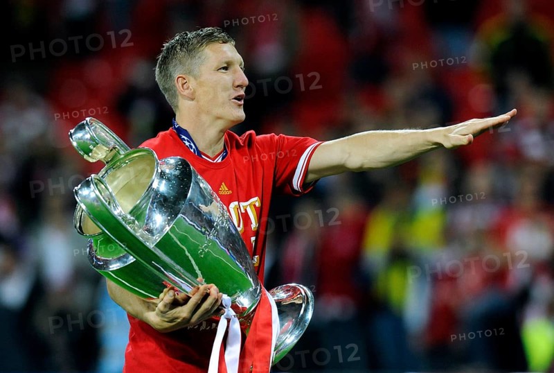 Bastian Schweinsteiger holding the trophy