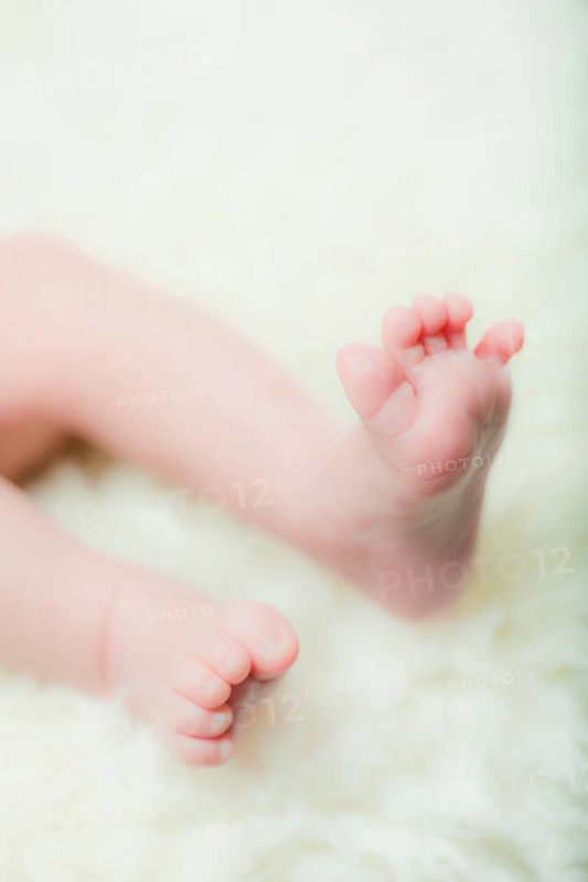 Feet of a baby on a sheepskin rug