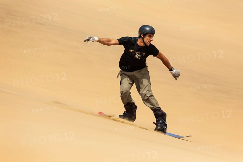 Man surfing the dunes