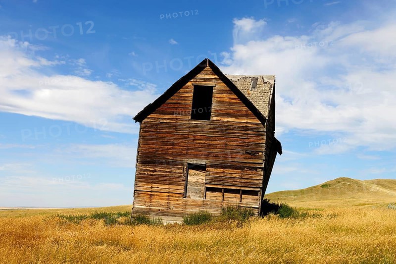 Abandoned and decaying house on the prairie