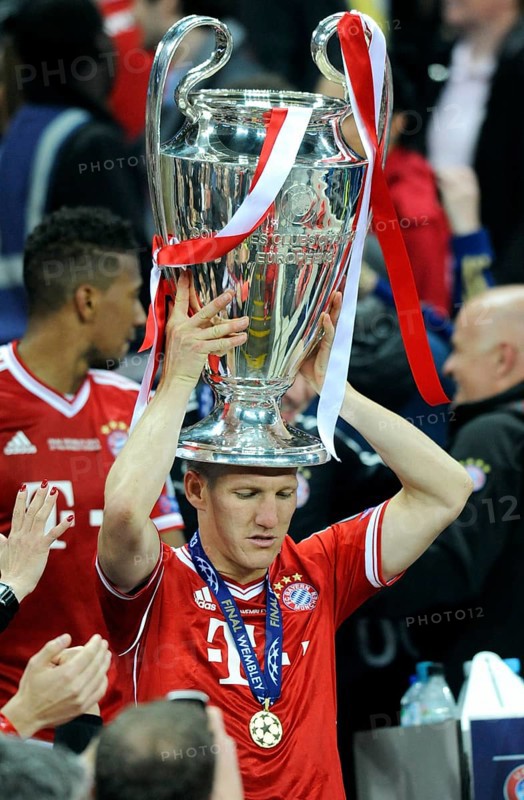 Bastian Schweinsteiger holding the trophy