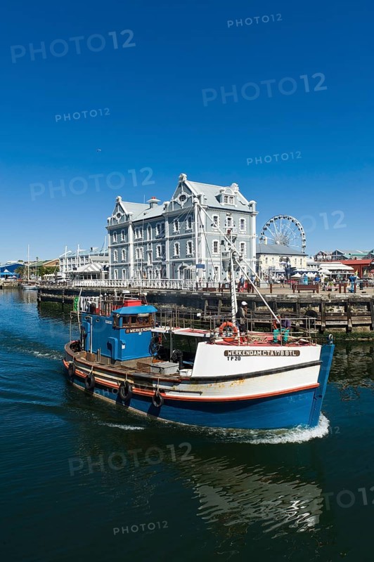 Fishing cutter in front of the African Trading Port building
