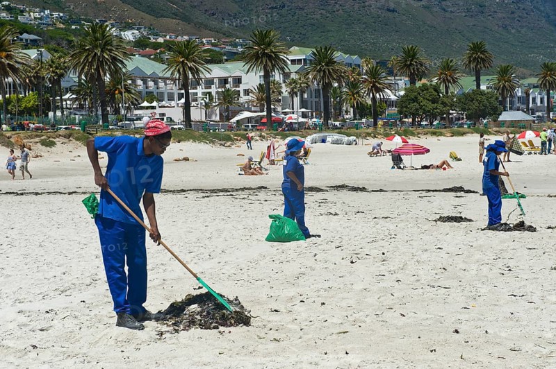 Workers cleaning Camps Bay Beach