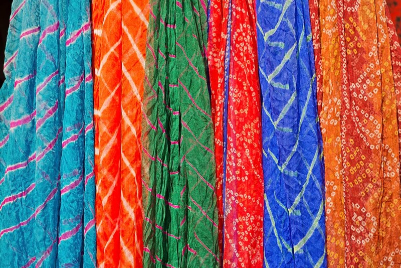 Colourful silk scarves are displayed for sale