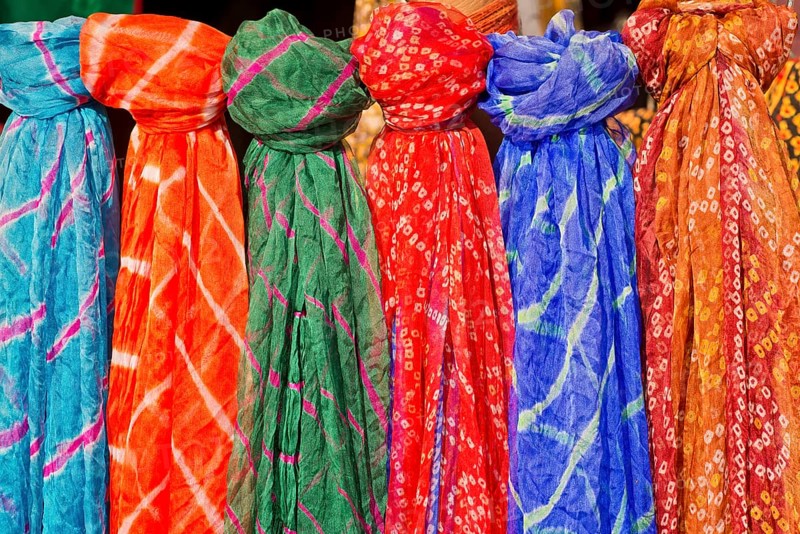 Colourful silk scarves are displayed for sale