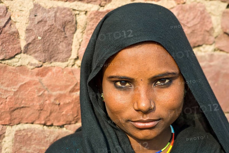 Young Indian woman wearing a black head scarf and a nose ring