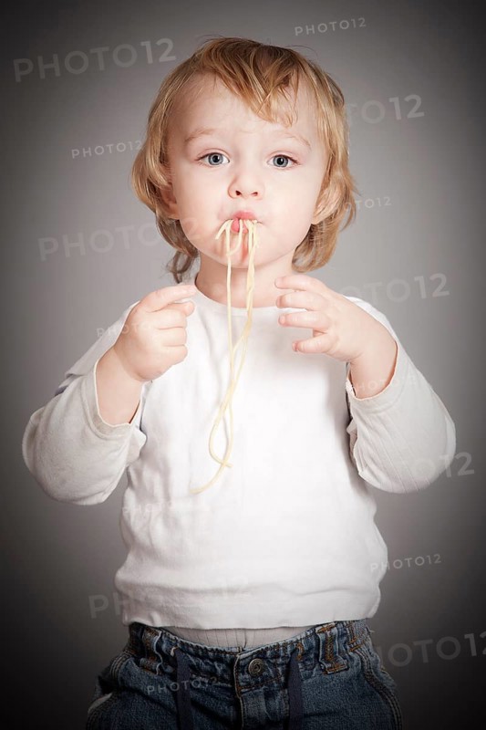 Boy eating spaghetti