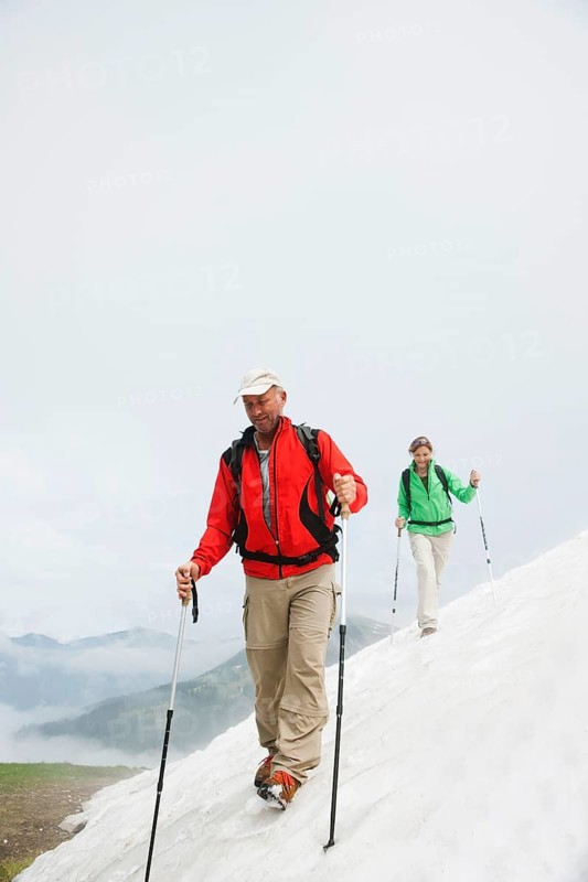Couple moving over a snow field during their hike to Mt. Neunerkoepfle