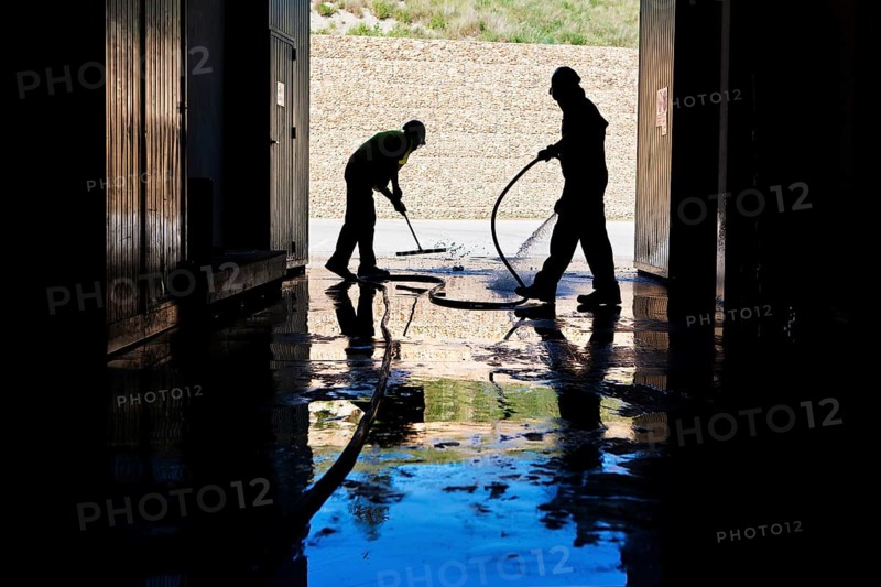 Workers cleaning a hall
