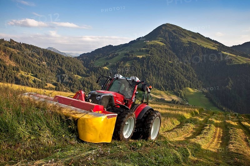 Tractor mowing hay