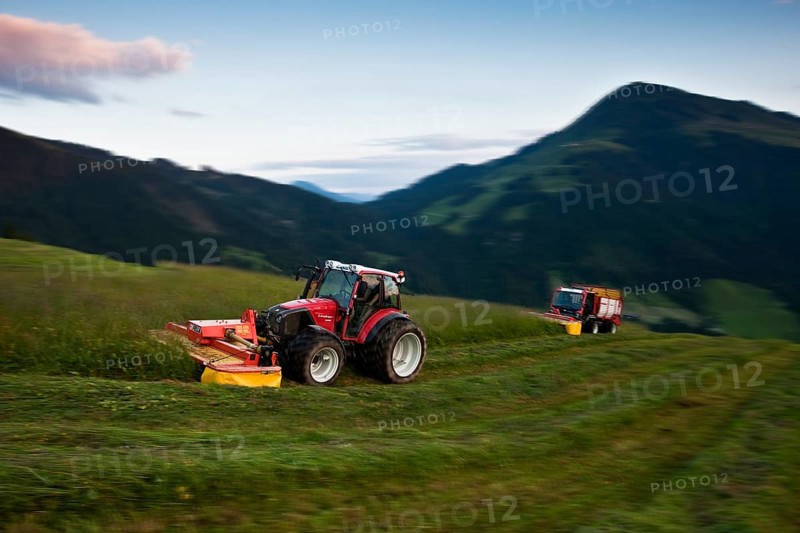 Tractor mowing hay