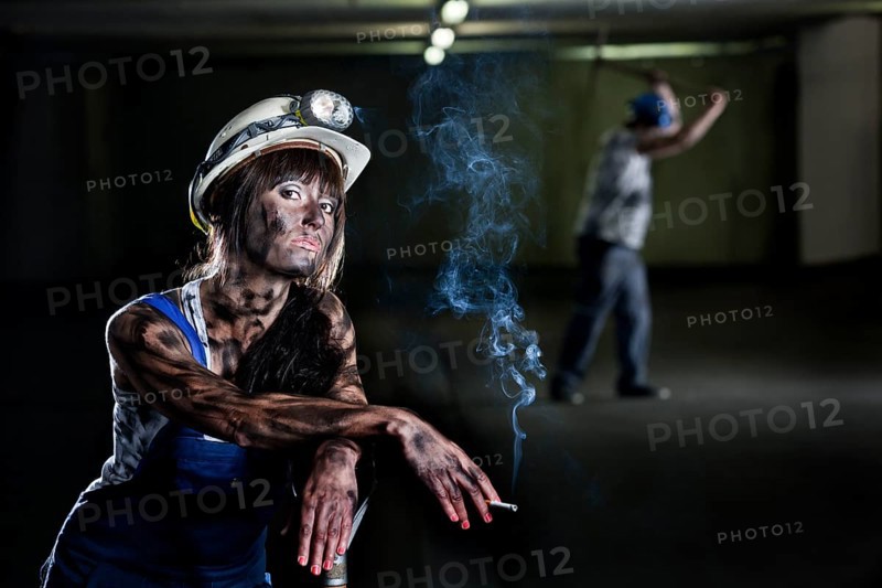 Female mine worker holding a cigarette