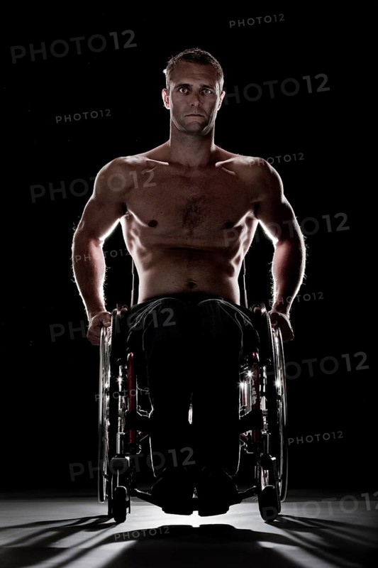 Muscular wheelchair user with a bare chest