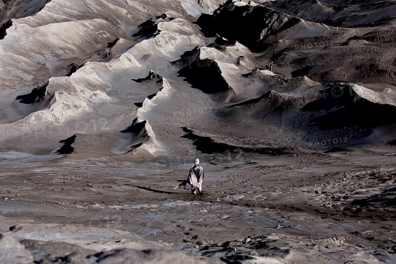Man bringing a sacrificial offering to Mount Bromo volcano