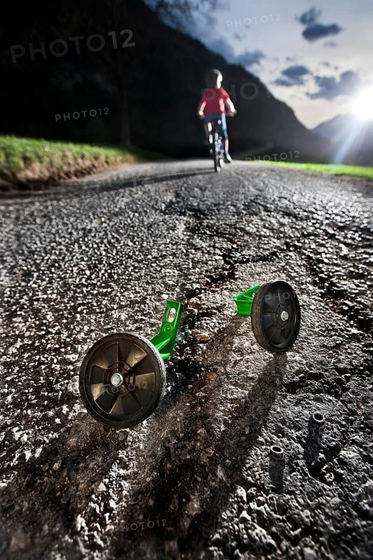 Boy riding a bicycle for the first time without training wheels