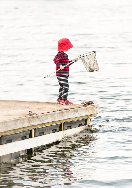 Child standing on jetty