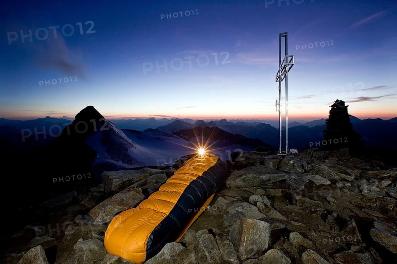 Mountain climber sleeping on the summit of Wilder Pfaff Mountain