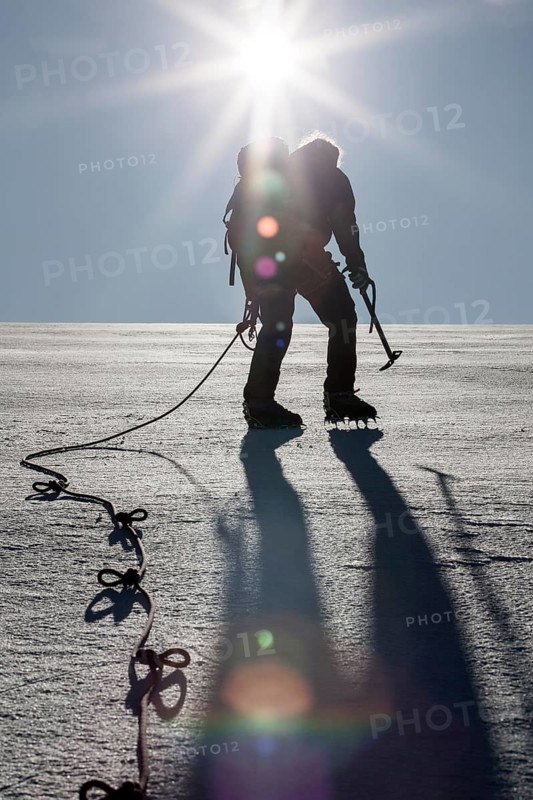 Mountaineers climbing a glacial field to Mt Schwarzenstein