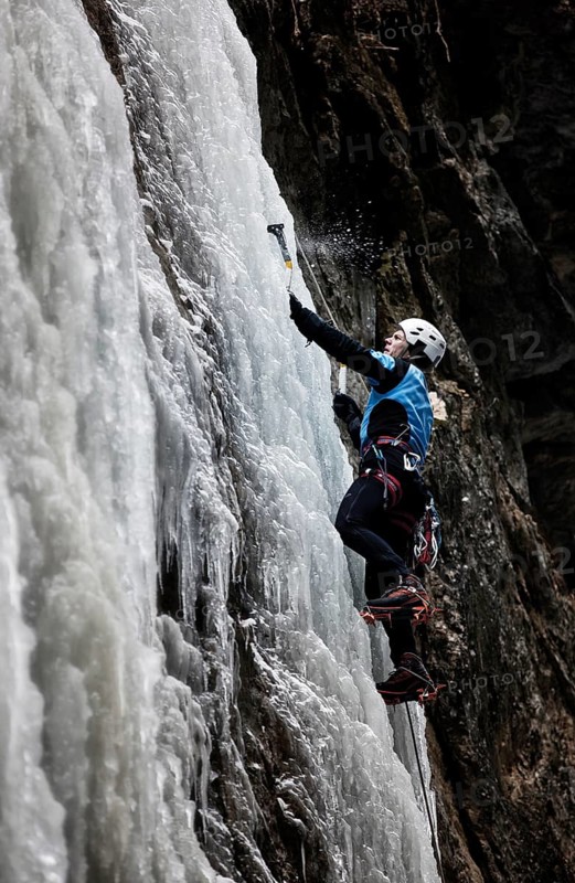 Ice climber climbing a frozen waterfall