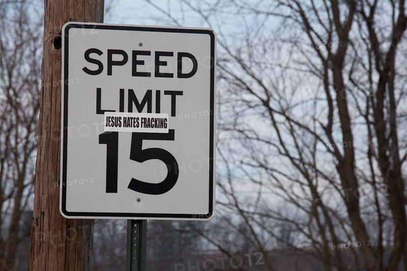 A sticker on a road sign near a natural gas well in the process of hydraulic fracturing or fracking in rural Lycoming County