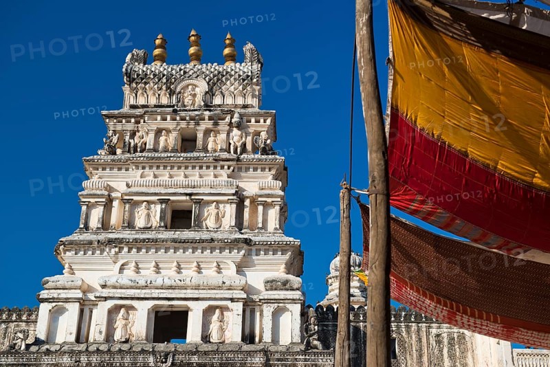 Depiction of gods and figures in white marble on a shikhara tower of a Hindu temple