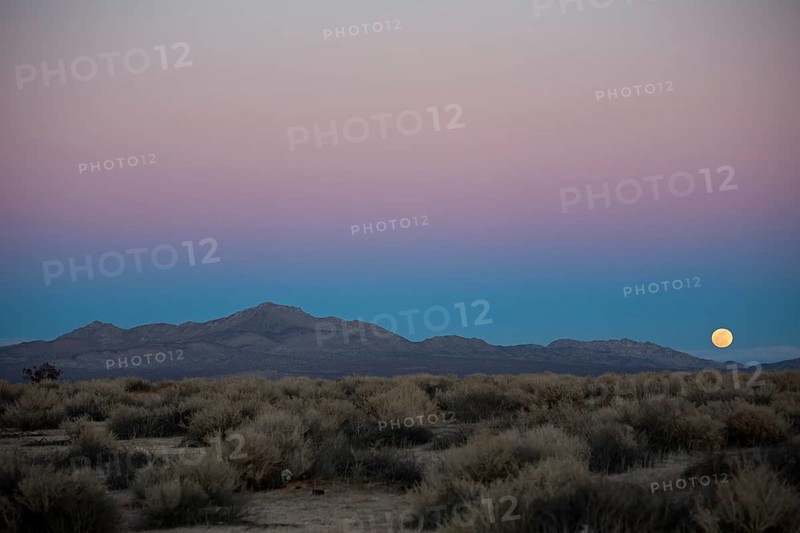 A full moon rises over Fremont Peak