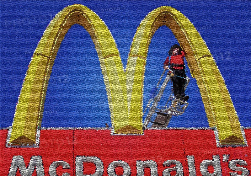 Worker repairing a Golden Arches sign