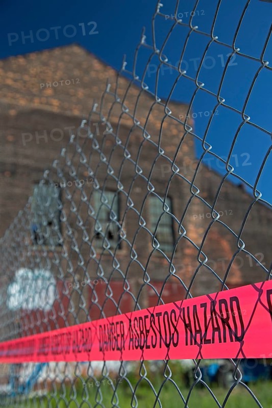 A warning of an asbestos hazard at the old Globe Trading Company building
