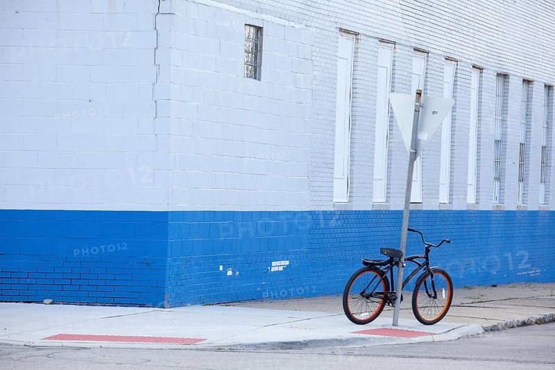 A bicycle parked on a street corner