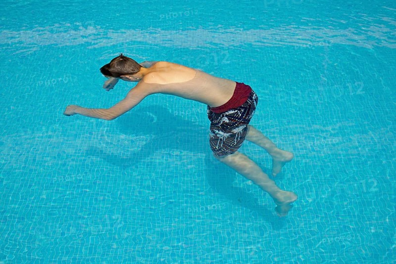 Motionless boy in a swimming pool