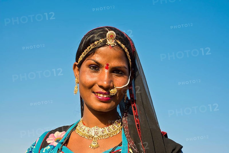 Smiling young Indian woman with a headscarf and jewellery