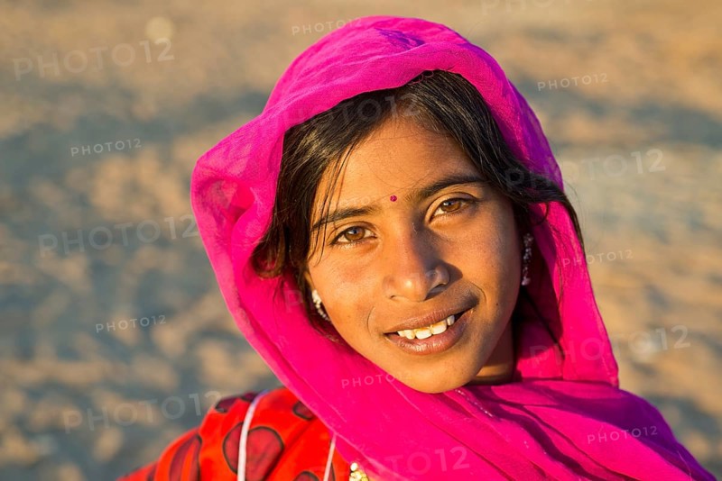 Smiling young woman with a headscarf and a bindi on her forehead