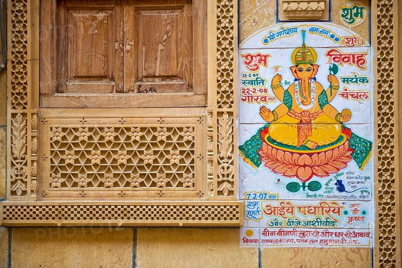 Decorated sandstone facade with a window opening and an effigy of the Hindu deity Ganesha