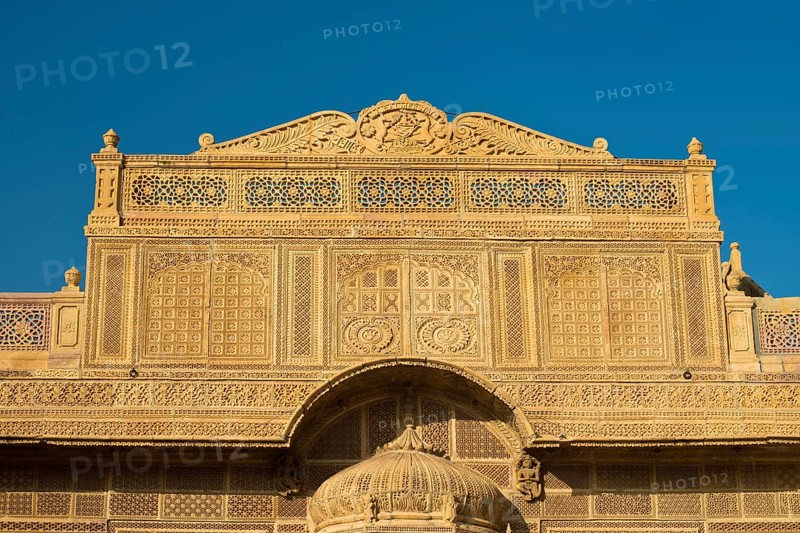 Richly decorated sandstone facade of an old Haveli or private mansion